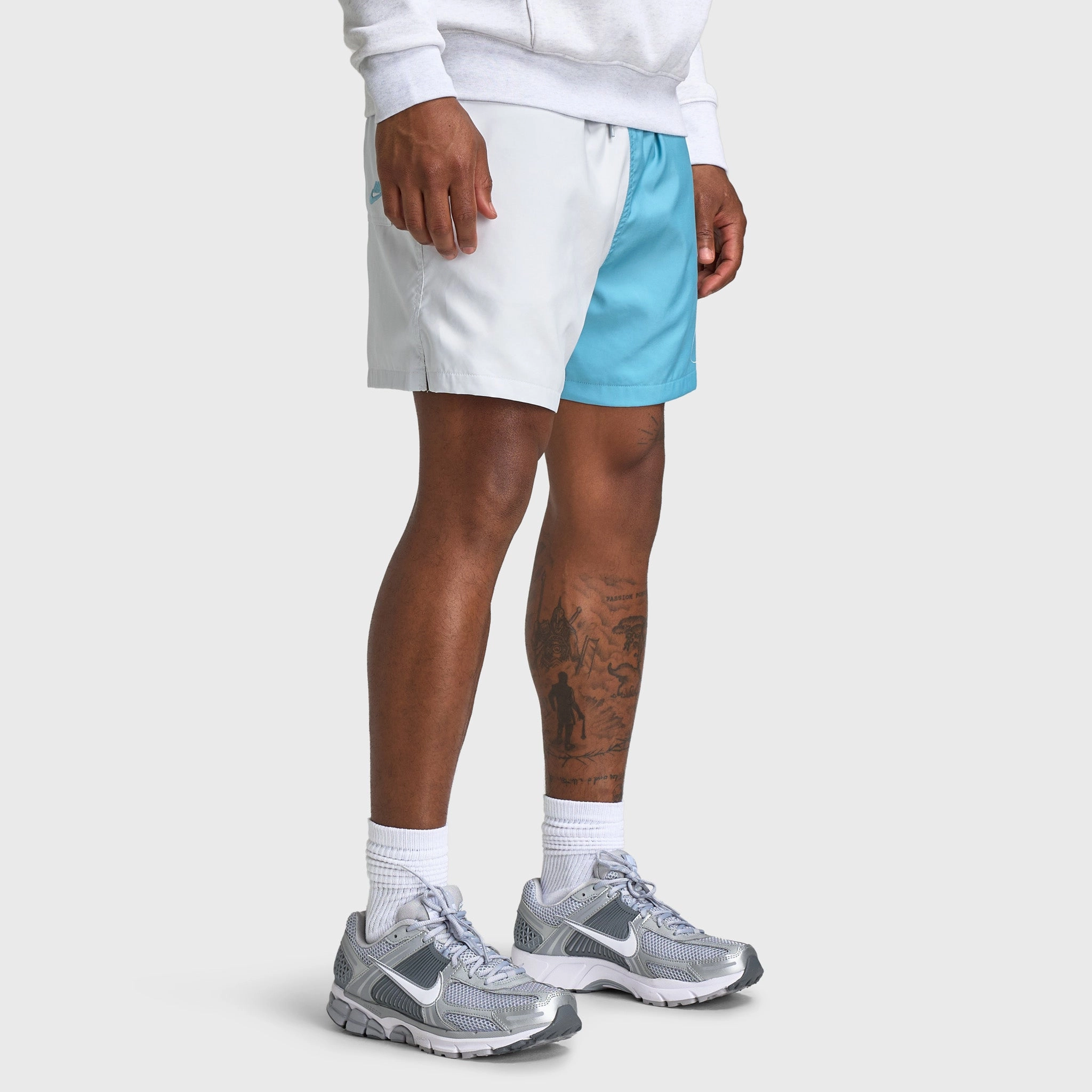 Contoured Cuff Design Nike Club 5" Flow Shorts Photon Dust / Denim Turq