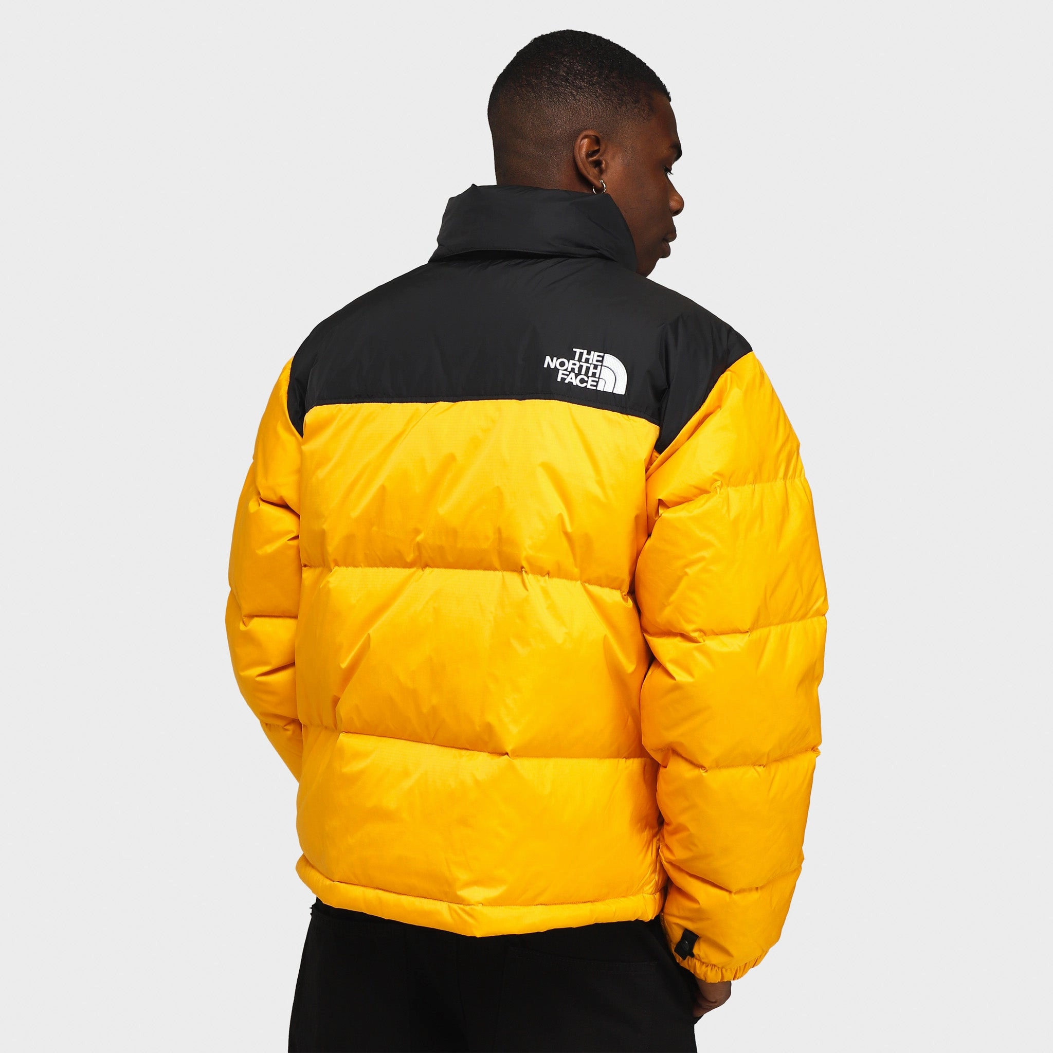 The North Face 1996 Retro Nuptse Jacket Summit Gold / TNF Black ribbon venue